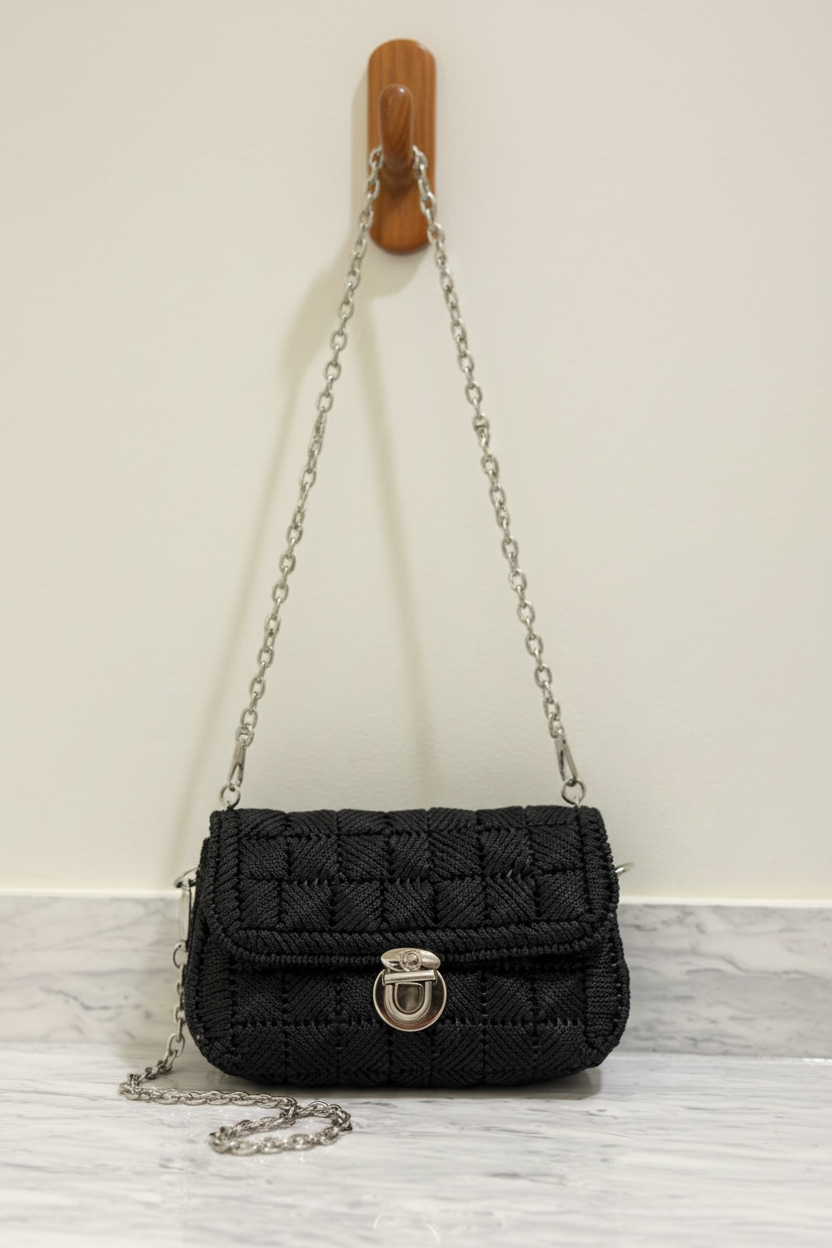 Black Yarn Sling Bag Hanging on Cabinet